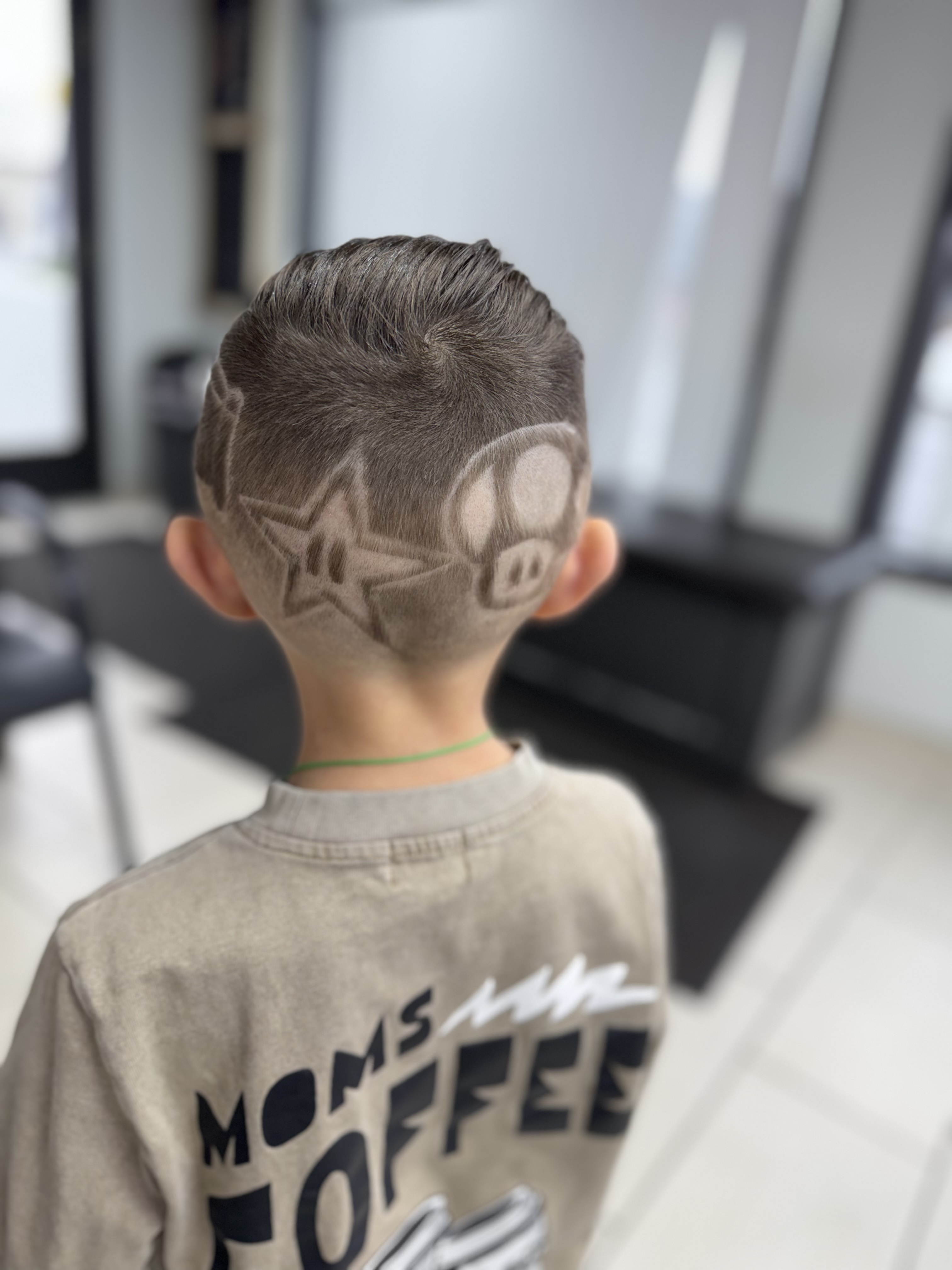 Kid's haircut with star and pig design